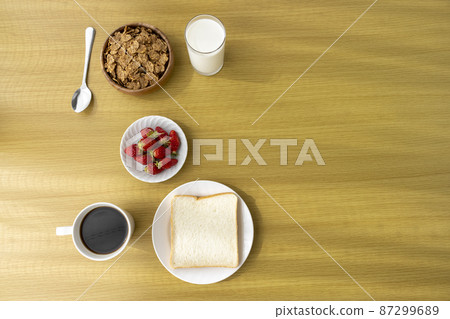 Image of breakfast (bread, flakes, strawberries, coffee, milk) 87299689