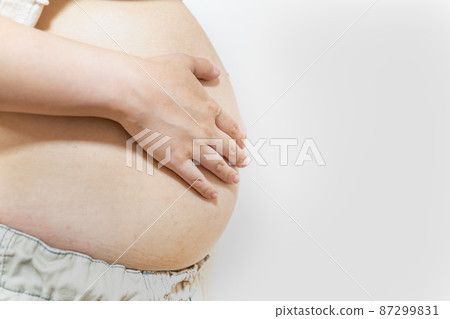 A photo of a pregnant woman. Image of pregnant women in late pregnancy and full month. 87299831
