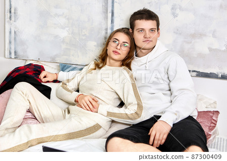 Young Married couple watch TV in bedroom. 87300409