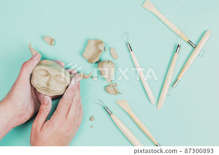 close up sculptor artist creating sculpture face with clay colored background close up sculptor artist creating sculpture face with clay colored background 87300893