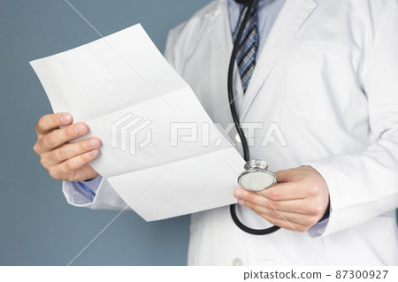 close up doctor with stethoscope holding medical report hand close up doctor with stethoscope holding medical report hand 87300927