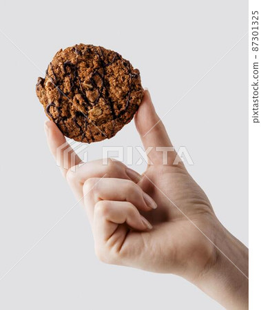 close up hand holding delicious cookies 87301325