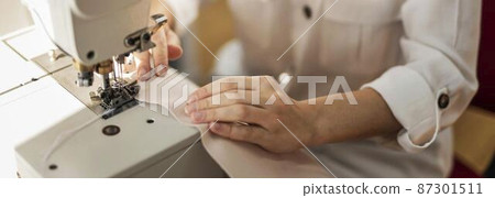 close up woman working with sewing machine close up woman working with sewing machine 87301511