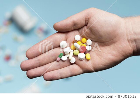 flat lay hand holding assortment pills flat lay hand holding assortment pills 87301512