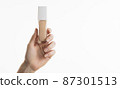 hand holding foundation bottle with copy space 87301513