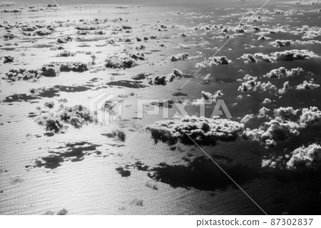 Beautiful clouds over the Atlantic ocean. Artistic black and white image. Beautiful clouds over the Atlantic ocean. Artistic black and white image. 87302837