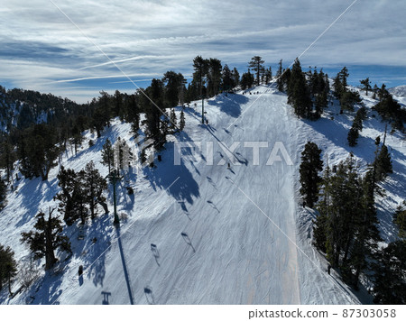 Ski lift seat and snowing mountain 87303058
