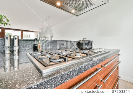 rustic kitchen with wooden furniture and an island in the middle rustic kitchen with wooden furniture and an island in the middle 87303344