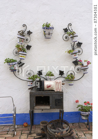 Flowerpots, Spain, Valencia on a white wall with a blue border in the restaurant 87304381