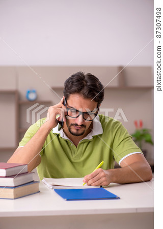 Young male student studying at home Young male student studying at home 87307498