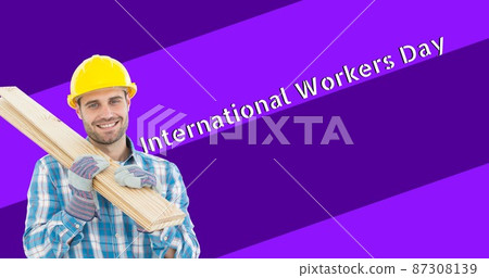Smiling caucasian construction worker holding planks by international workers day 87308139