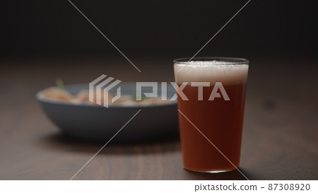 grapefruit drink in tumbler glass with blue bowl on background grapefruit drink in tumbler glass with blue bowl on background 87308920