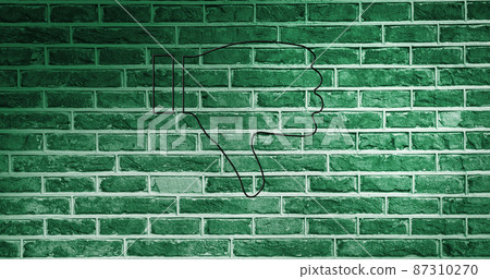 Image of glowing neon thumb down icon on brick wall 87310270
