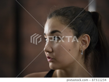 Young pretty woman in sport clothes. Looking to the side. Portrait Young pretty woman in sport clothes. Looking to the side. Portrait 87311234