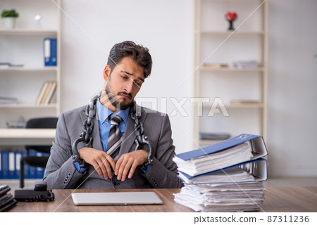 Young chained male employee sitting in the office 87311236