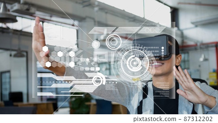 Digital interface with data processing against african american woman wearing vr headset 87312202