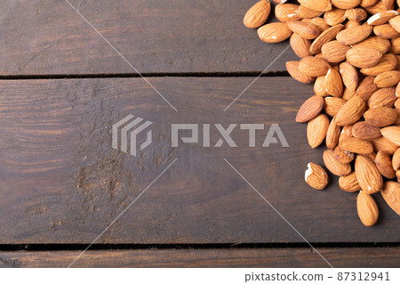 Close-up of healthy almonds on wooden table with empty space Close-up of healthy almonds on wooden table with empty space 87312941