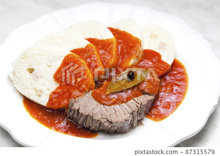 beef meat with tomato sauce and dumplings beef meat with tomato sauce and dumplings 87315579