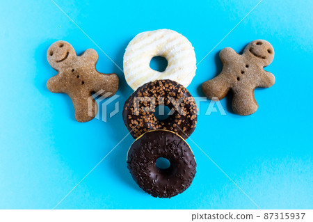 Donut with hazelnuts on blue background, close up Donut with hazelnuts on blue background, close up 87315937