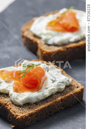 whole grain bread with dill spread and smoked salmon 87316228