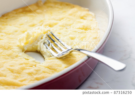 still life of cheese raclette in baking plate 87316250