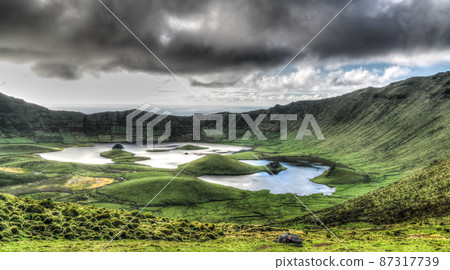 Landscape sunset view to Caldeirao crater, Corvo island, Azores, Portugal Landscape sunset view to Caldeirao crater, Corvo island, Azores, Portugal 87317739