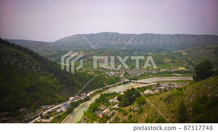 Panoramic aerial view to Berat old town and Osum river from Berat Castle , Albania Panoramic aerial view to Berat old town and Osum river from Berat Castle , Albania 87317748