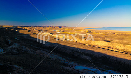 Panorama view to Aral sea from the rim of Plateau Ustyurt near Aktumsuk cape at sunset, Karakalpakstan, Uzbekistan Panorama view to Aral sea from the rim of Plateau Ustyurt near Aktumsuk cape at sunset, Karakalpakstan, Uzbekistan 87317845