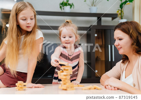 mom and daughters play blocks. educational and interesting games for family. mom and daughters play blocks. educational and interesting games for family. 87319145