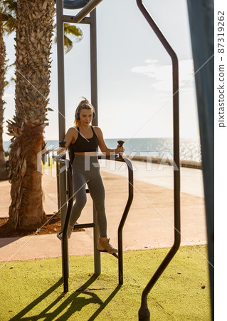 Young fitness woman doing exercises in park Young fitness woman doing exercises in park 87319262