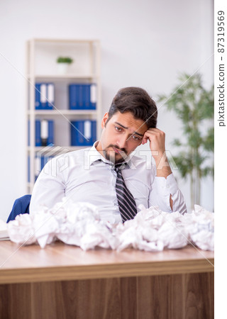 Young male employee in brainstorming concept 87319569