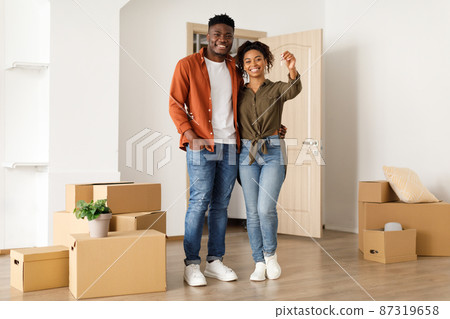 Joyful Black Couple Showing Key Standing In New House 87319658