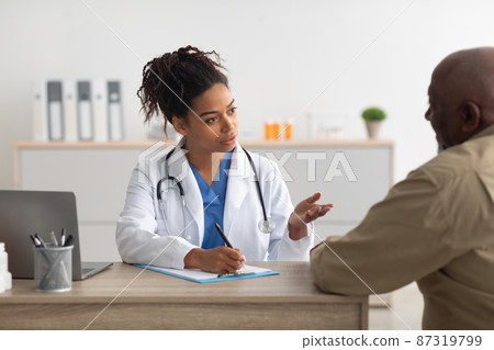Young black doctor explaining treatment plan to male patient 87319799