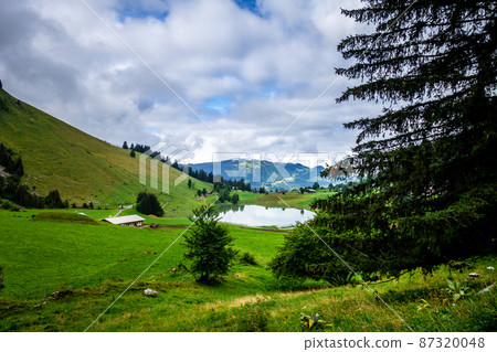 Lake of the Confins and Mountain landscape in La Clusaz, France 87320048