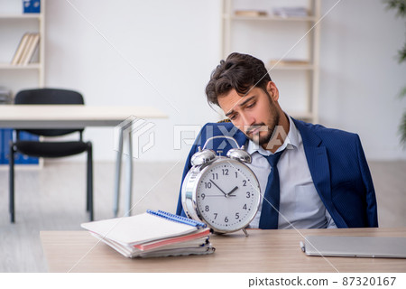 Young male employee in time management concept 87320167