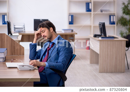 Young male employee working in the office 87320804