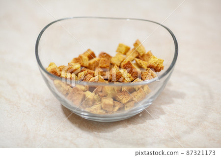 Small crackers in a glass transparent bowl Small crackers in a glass transparent bowl 87321173
