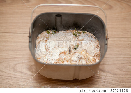 Prepared bread mix in a bread machine bucket 87321178