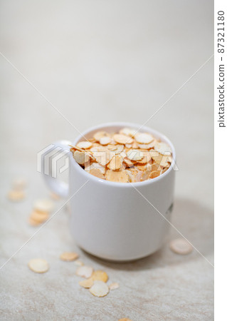 Pea flakes in a white mug Pea flakes in a white mug 87321180