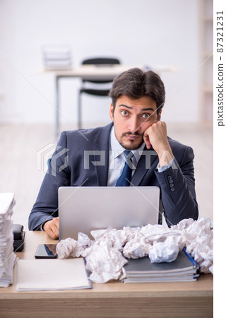 Young male employee in brainstorming concept 87321231