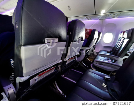 Empty whole row of passenger seats in flying airplane during Covid-19 pandemic 87321637
