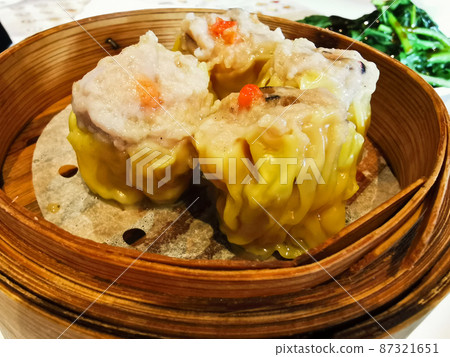 Siu Mai steamed pork prawn mushroom Chinese dumplings in bamboo basket in Yum Cha restaurant Siu Mai steamed pork prawn mushroom Chinese dumplings in bamboo basket in Yum Cha restaurant 87321651