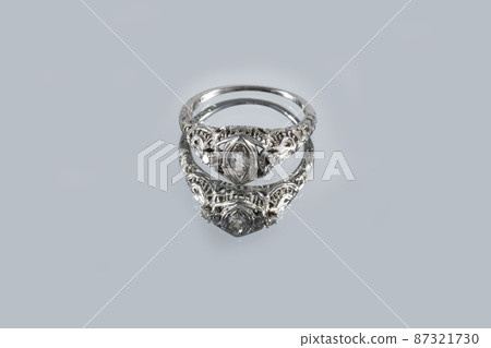 Vintage French white gold ring with natural diamonds with reflection on a gray background, art Deco style 87321730