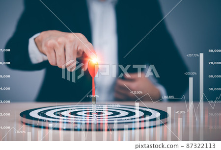 Targeting the business concept, Businessman touch red dart to the virtual target dartboard, Executive marketing, investment goal and target for business investment concept, 87322113