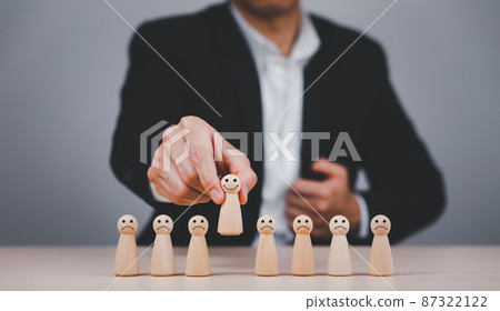Businessman hand touch wooden Human resources officer looking for leader and CEO concept, Leader leave his comfort zone and get out of the crowd. Personal development, motivation and challenge. 87322122