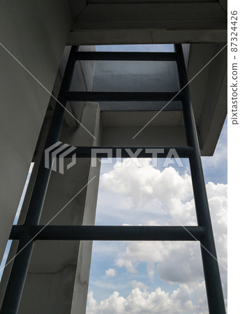 The metal ladder near the outside of the meeting room for climbing to the rooftop. The metal ladder near the outside of the meeting room for climbing to the rooftop. 87324426