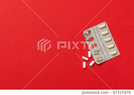 Protective face masks or surgical masks, medicine pills and thermometer on table background. Coronavirus disease. Corona virus concept. Space for text 87325976