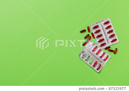 Protective face masks or surgical masks, medicine pills and thermometer on table background. Coronavirus disease. Corona virus concept. Space for text 87325977