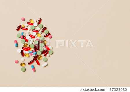 Protective face masks or surgical masks, medicine pills and thermometer on table background. Coronavirus disease. Corona virus concept. Space for text 87325980