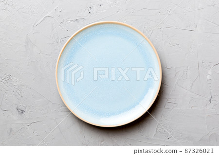 Top view of empty blue plate on cement background. Empty space for your design Top view of empty blue plate on cement background. Empty space for your design 87326021